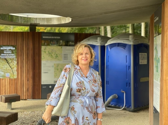 Raadslid Isabelle Vandenbrande bij de voorlopige toiletten bij provinciedomein Bulskampveld